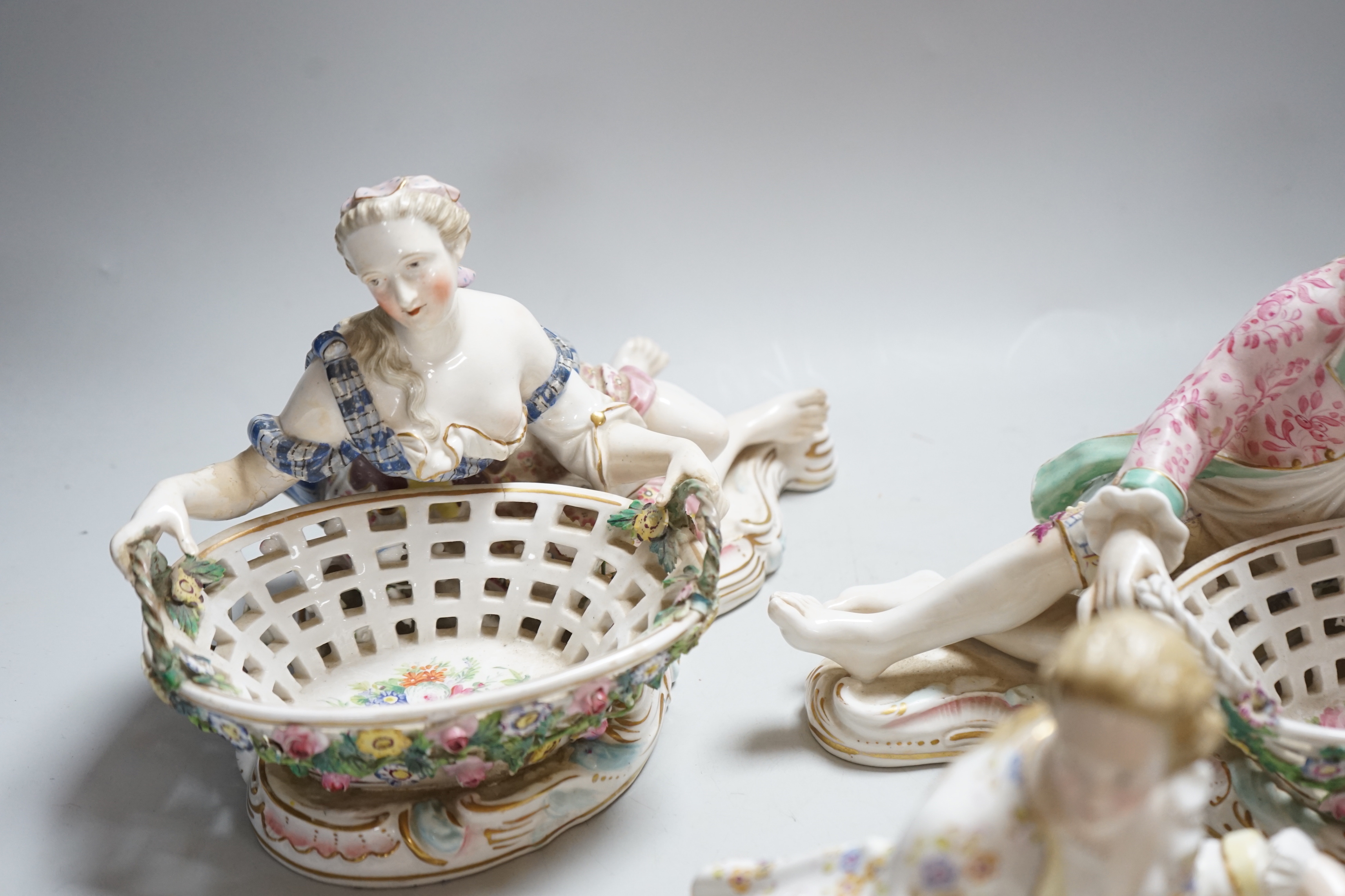 Three English porcelain Meissen style figural baskets, highest 18cm